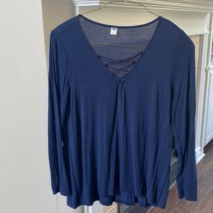 Long sleeved navy knit top. V-neck with cute design at V in front.